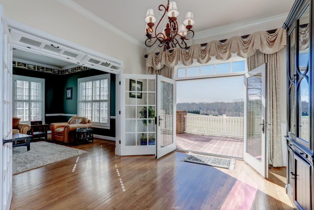 FEATURES Welcoming foyer leads to the grand center hall of this bright and spacious home Gorgeous hardwood floors, crown molding, wooden shutters, and high ceilings throughout the open floor plan