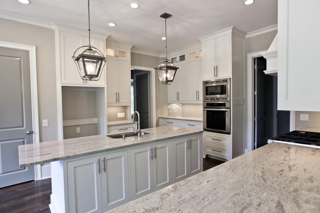 b b e d h a r dwo o d s, brushed nickel hardware and stainless steel appliances.