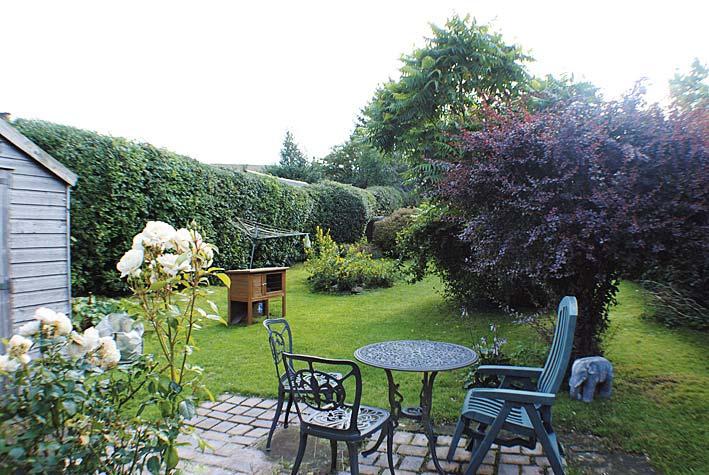 The garden to the rear is fully enclosed by hedgerow to both sides and wooden fencing at the bottom. It is laid to lawn with a Monoblock pavier patio area, flower borders with mature trees and shrubs.