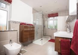gardens, there is a walk in dressing room leading to an en-suite shower room/w.c.