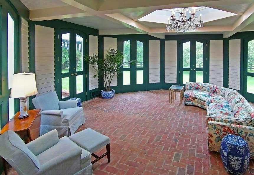 Sun Room 20 x 20 approximate and irregular Octagonal shaped; brick floor laid in herringbone pattern; full light cupola with decorative chandelier;