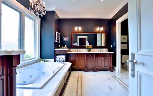Heated marble floor Large jet tub with marble surround Custom built-in vanity with marble countertop Double undermount sink Separate walk-in