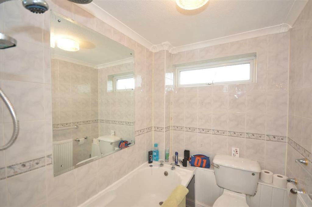 MAIN ROOMS AND DIMENSIONS Bathroom Low level WC, wash basin, panel bath with over head shower. White suite with tiled walls, vinyl flooring, single radiator and UPVC double glazed window.