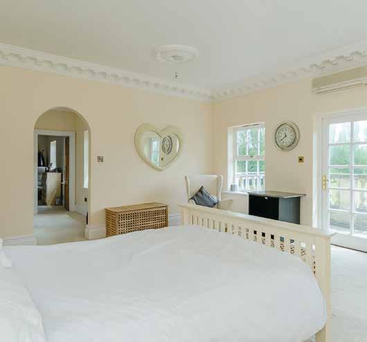 The master bedroom with a balcony looking out on to the garden is one of