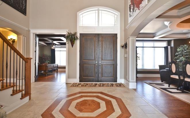 allowing for plenty of natural light. This foyer offers beautiful ceramic tiles with wood inlay floor.