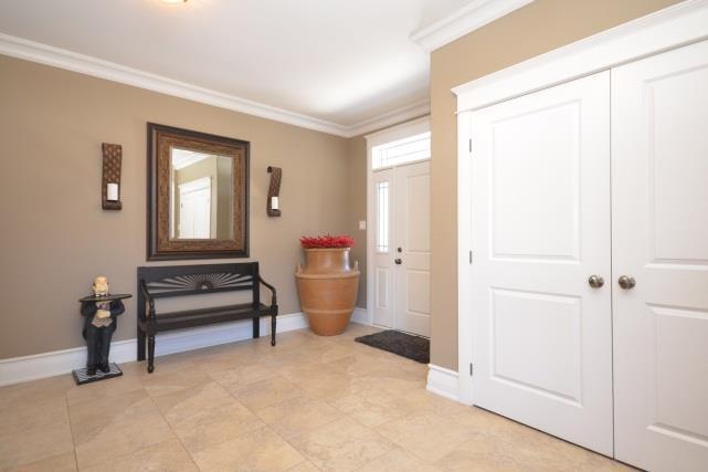 The 2 piece powder room is located down the hallway near the kitchen. This space offers ceramic tile floors, toilet & vanity with glass bowl sink.