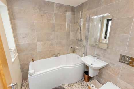 hand basin with mixer tap, panelled bath with