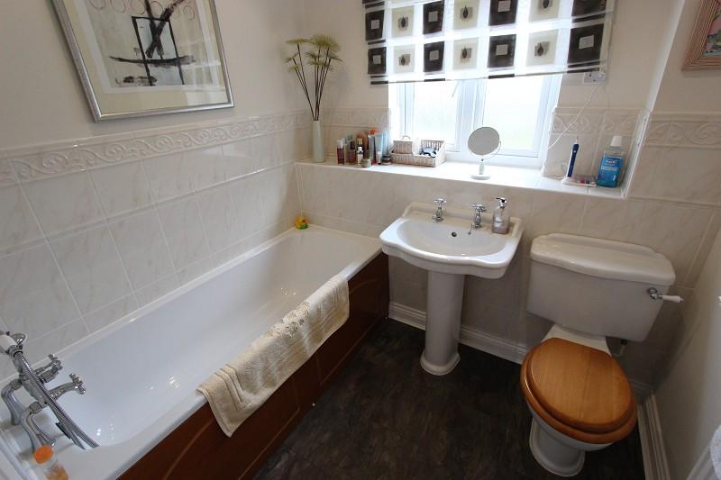 mprising of bath with shower head over, w.c. and wash hand basin, one radiator, upvc window to rear, half tiled walls.