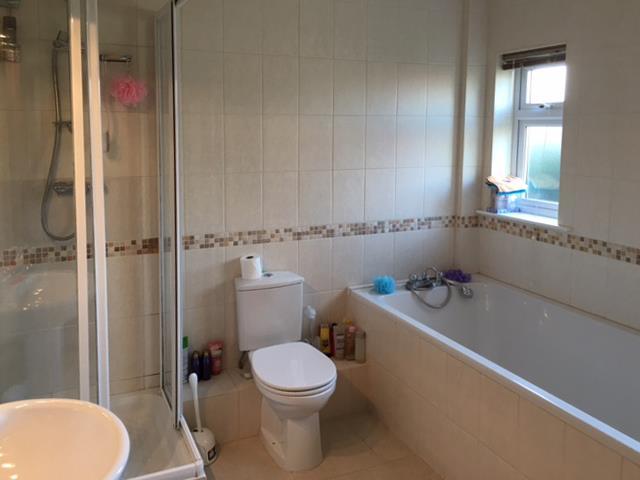 Bathroom 9 6 x 8 7 Fitted with a four piece white suite comprising bath with shower attachment, corner shower cubicle, basin and wc. Tiled floor and walls.