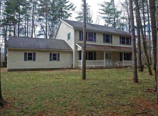 The property features a frame construction with vinyl siding exterior, asphalt shingle roof, painted aluminum gutters and downspouts, a full walkout basement, an attached two-car garage, a covered