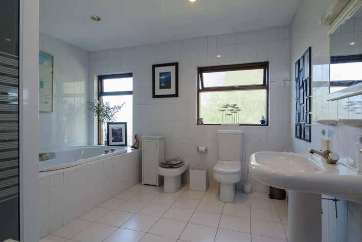 MASTER BEDROOM: 14' 0" x 10' 9" (4.27m x 3.28m) ENSUITE SHOWER ROOM: White suite comprising low flush WC. Vanity unit. Fully tiled shower cubicle with Redring shower. Half tiled walls.