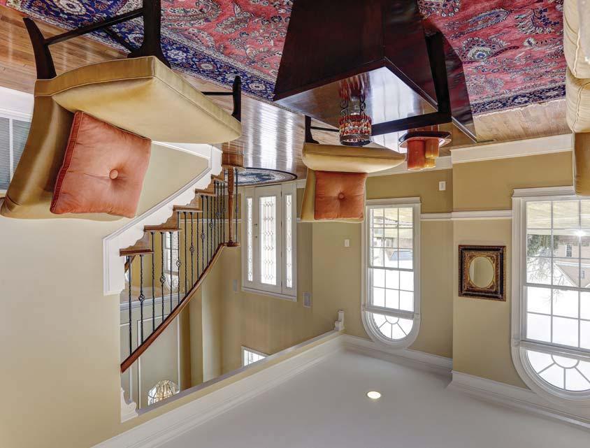 A grand two-story foyer and sweeping double staircase highlights the home s open floor plan with adjacent formal living and dining rooms complete with elegant accent moldings and beautiful hardwood