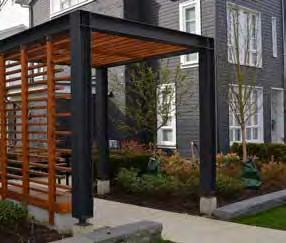 4.7.2 Entrance Guidelines: a. Entrances should be expressed in the overall form as a welcoming, sheltered design element. Consider incorporating wood into the entry design including doors and soffits.