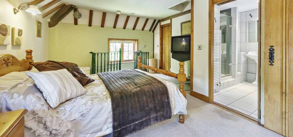 Surrounded by an acre of gardens and grounds that afford uninterrupted views across open countryside, it is beautifully tranquil, and the interior is bursting with characterful features such as