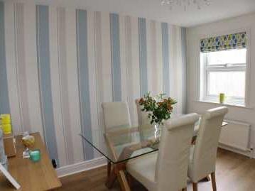 reception rooms, a modern fitted kitchen overlooking the rear garden and on the first there