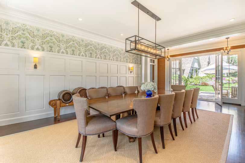 The formal dining room features french doors that lead