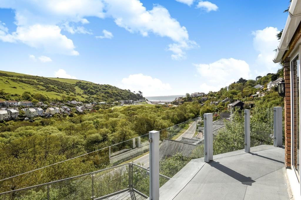 Overboard comprises a detached house set in an elevated location only 400 metres from the beach and commanding a stunning 180 degree panorama over Seaton Beach and the unspoilt woodland valley.