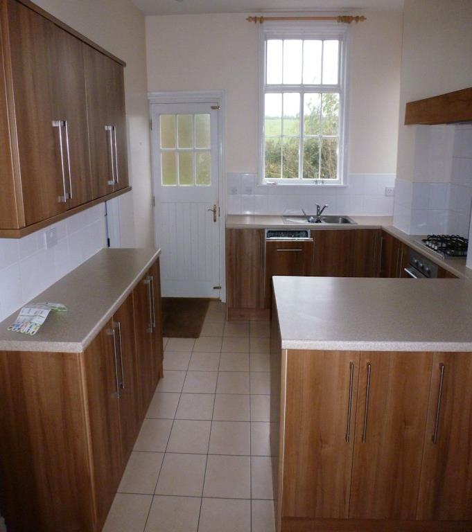 Integrated dishwasher. Single drainer 1½ inset sink unit with mixer tap over. Tiled floor. Double aspect glazed sash windows.