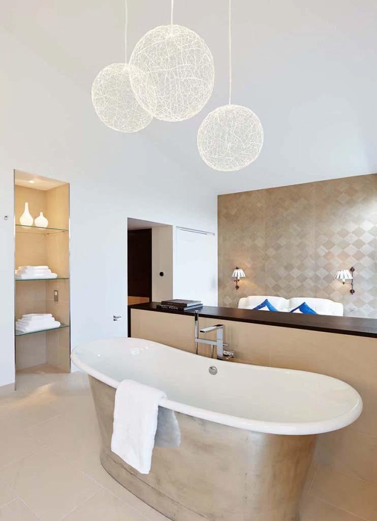 The freestanding bath tub sits in the middle of the room, creating a feature element in the bathroom.