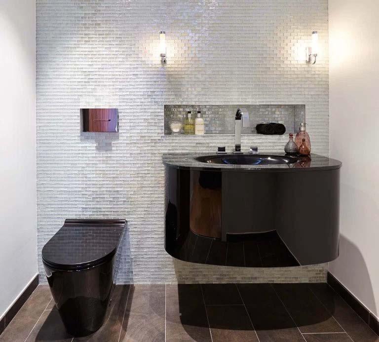 The powder room was a great success too. The black glass washbasin is set off against jewel-like glass mosaic tiles to create a wonderful contrast.