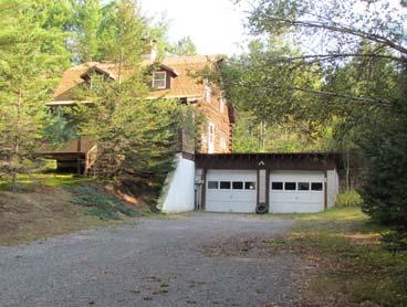 ranch located on snowmobile/atv trails with 2 car detached garage, full basement & one acre